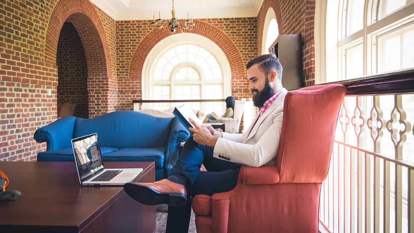 A graduate at the library: Pursue a Master of Business Administration (MBA) in Innovation Management at Regent University.