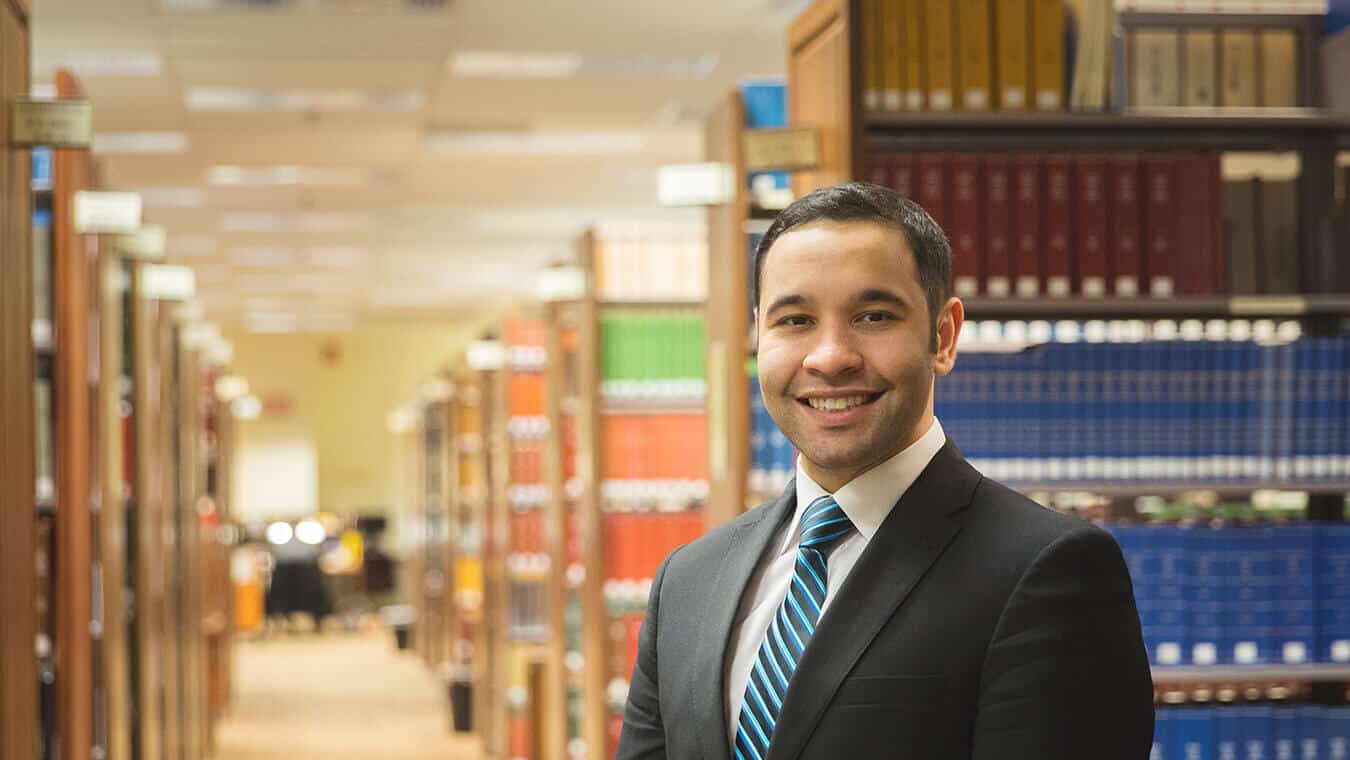 A graduate at the library: Explore the Juris Doctor Honors law program offered by Regent University, Virginia Beach.