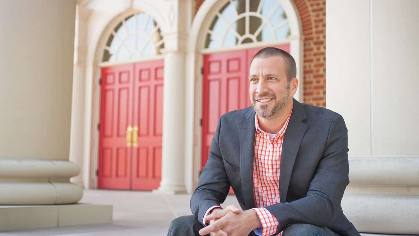 A alumnus outside the chapel: Pursue your master's in spiritual formation degree online at Regent University.
