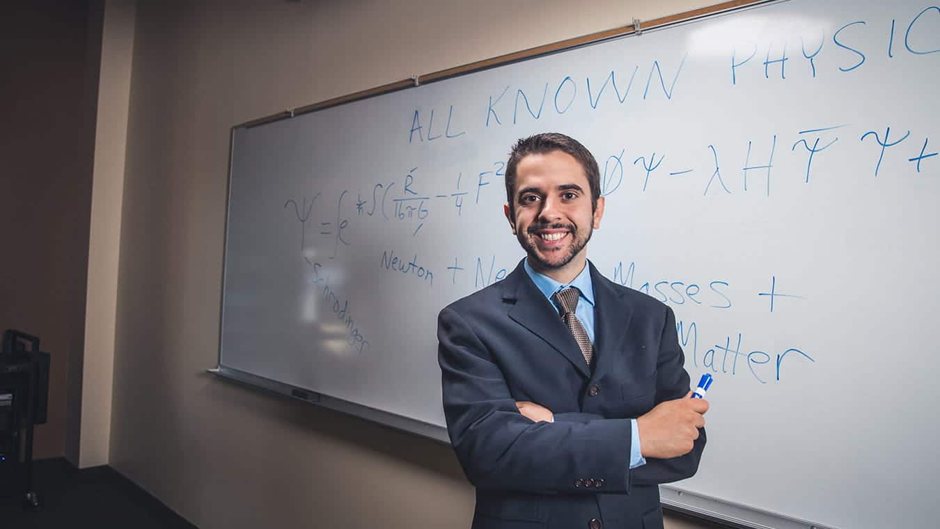 A professor in front of a whiteboard: Explore the Certificate in Science, Technology, Engineering & Mathematics (STEM) offered by Regent University.