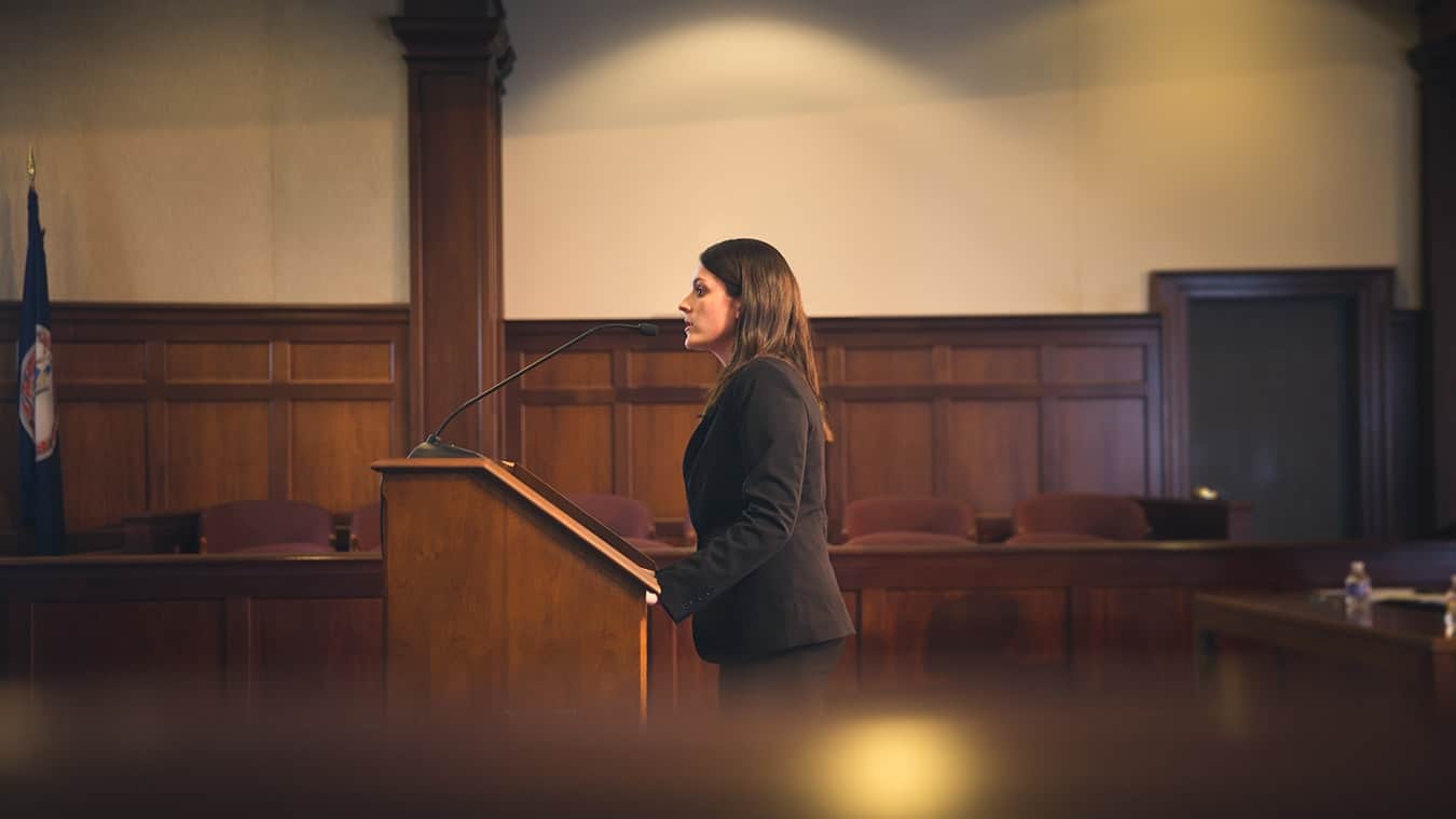 A student at the moot court room: Pursue a Master of Arts in Government – Law and Public Policy degree at Regent University.