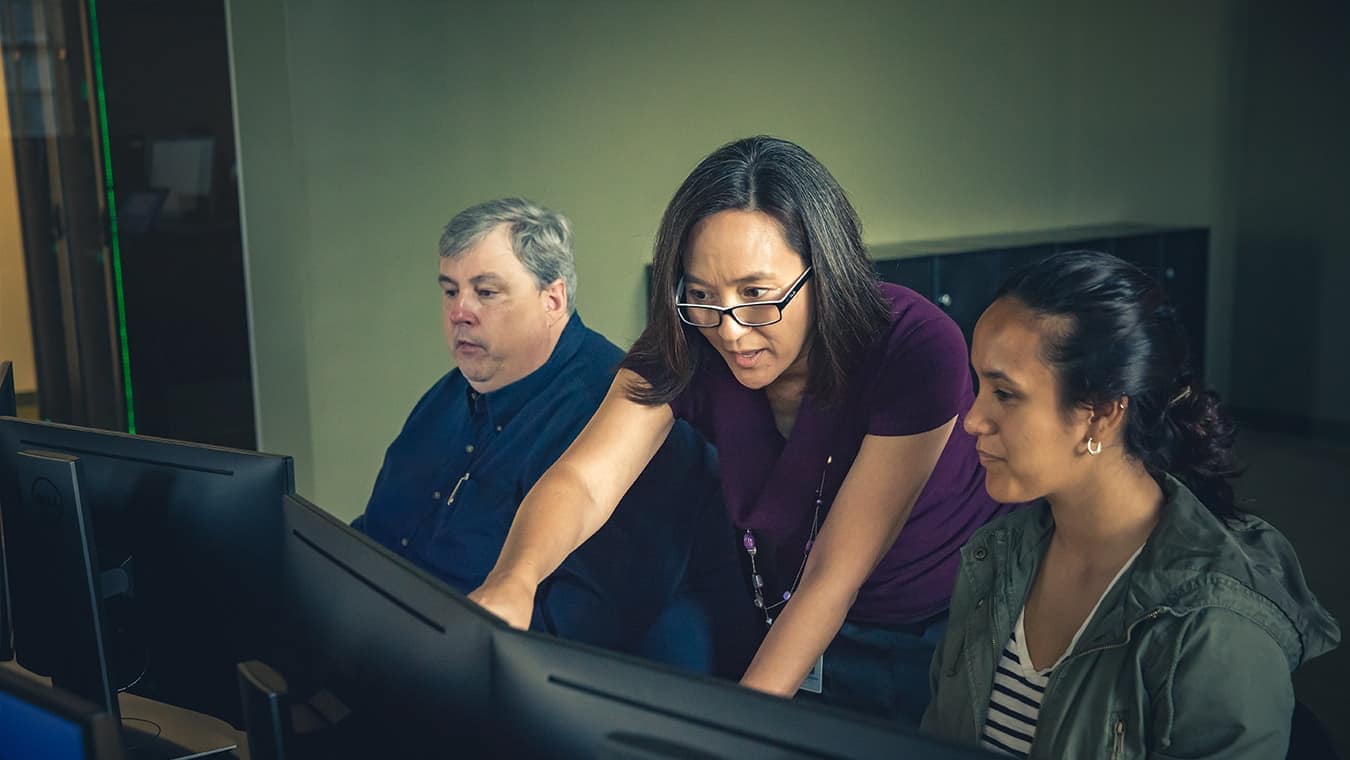 A professor teaching a student: Pursue your B.S. in Computer Engineering degree online at Regent University.