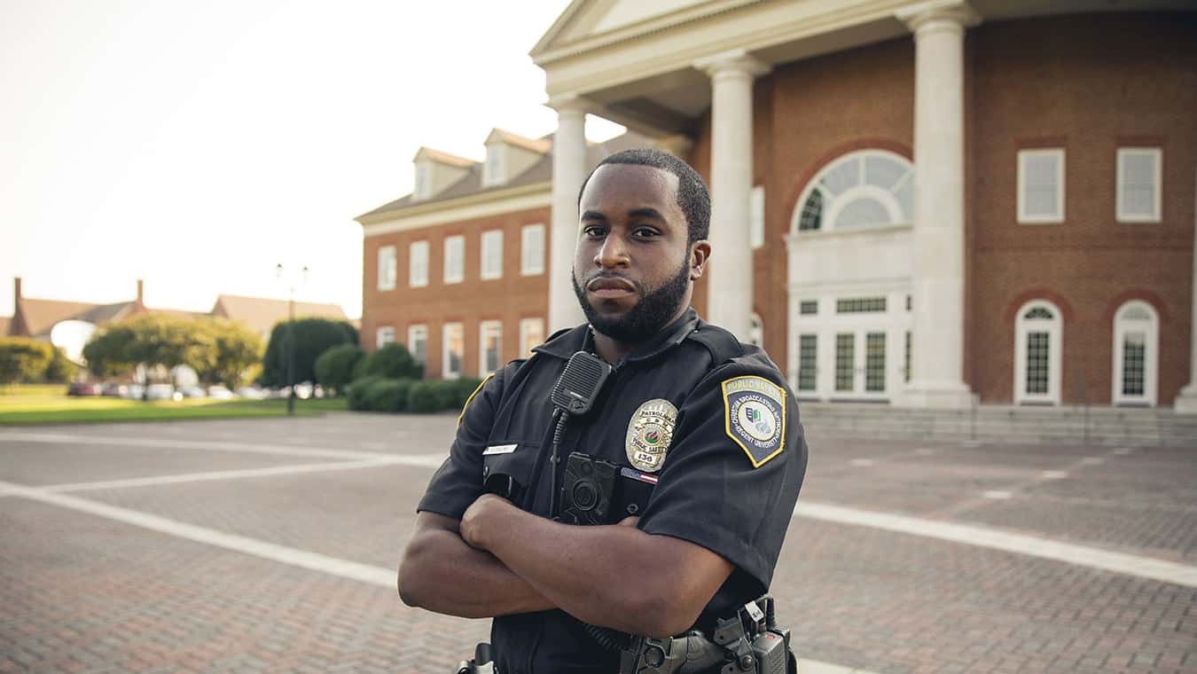 A police officer on campus: Explore the Bachelor of Science in Professional Studies - Criminal Justice program offered by Regent University.