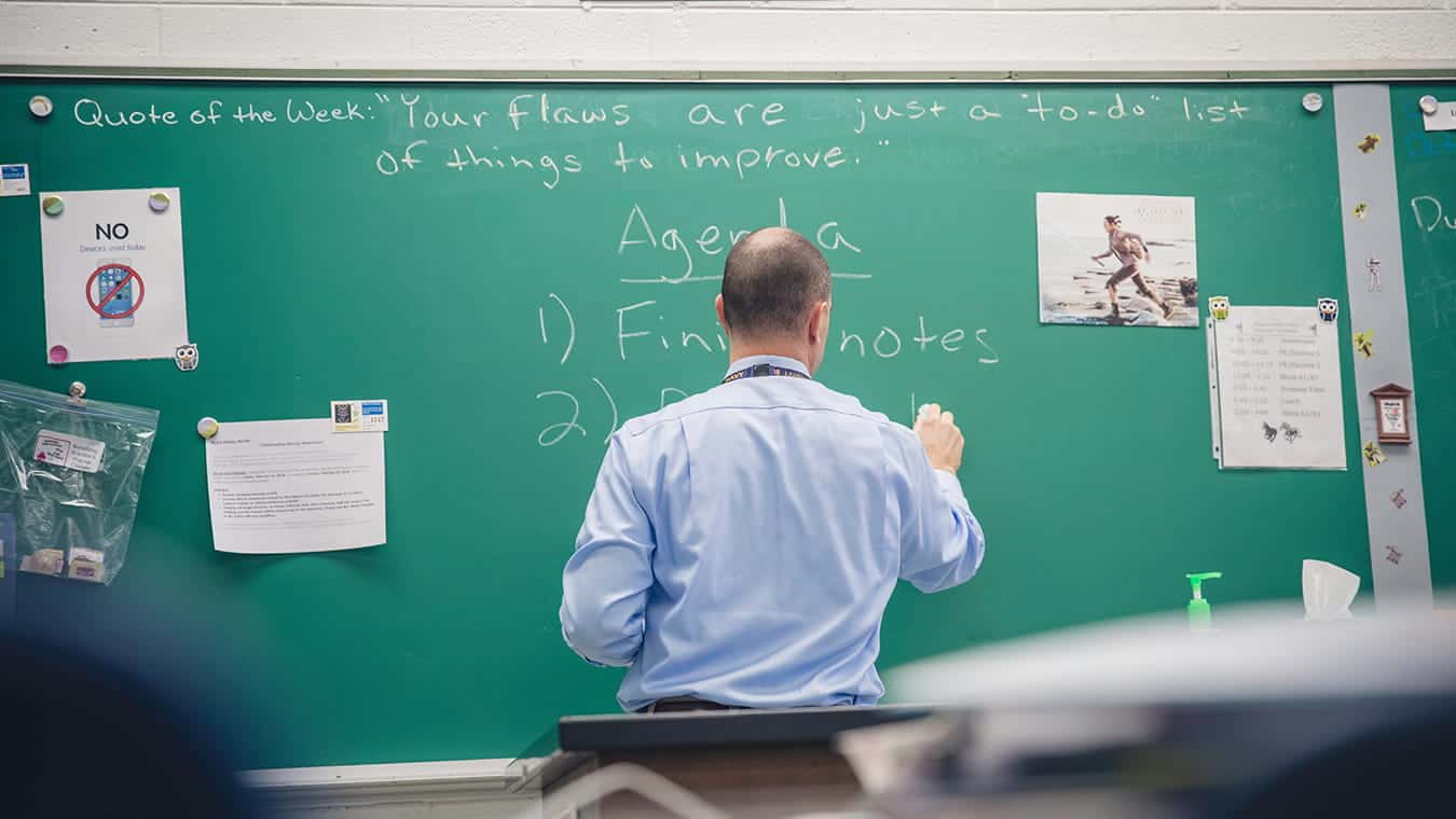 A teacher writing on a chalkboard: Explore Regent University’s STEM minors, offered online and in Virginia Beach, VA 23464.