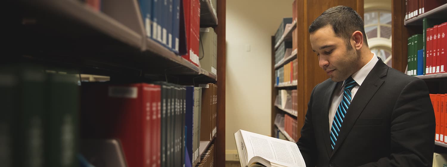 A student leafs through a book at the Regent University Library in Virginia Beach.