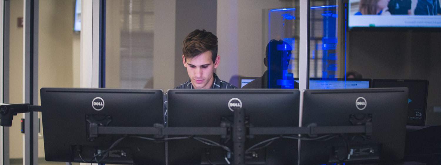 A graduate working at the cyber lab: Regent University, Virginia Beach, offers a digital forensics minor online.