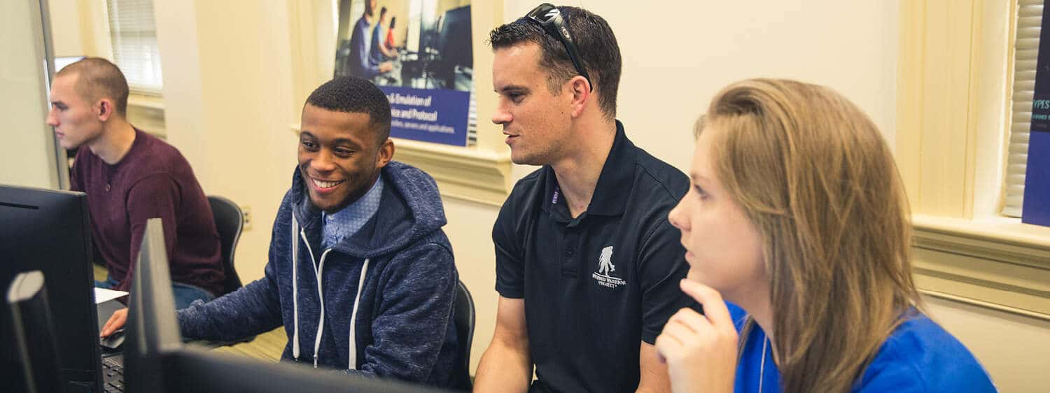 Students in a classroom: Pursue a B.S. in Computer Science degree program at Regent University.