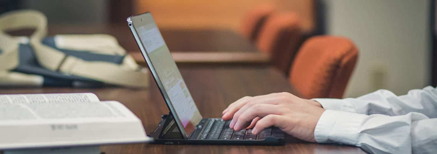 A person studies online at Regent, which offers a range of online master's programs.