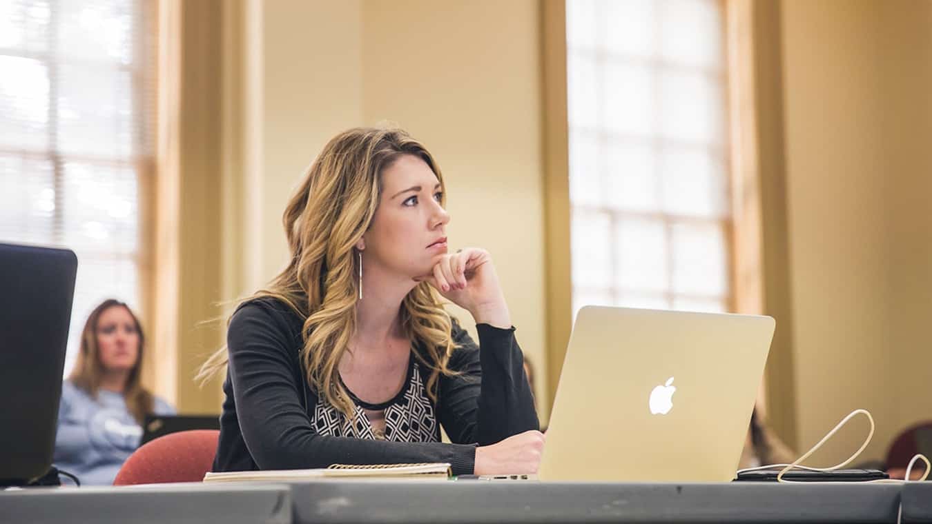 A student in a classroom: Pursue an individualized PhD in Organizational Leadership at Regent University.
