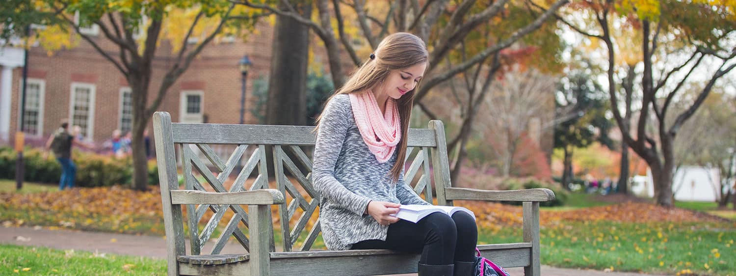A student reads on Regent University's campus in Virginia Beach.