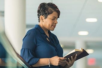 A lady looks at a Bible at a church in Virginia Beach.