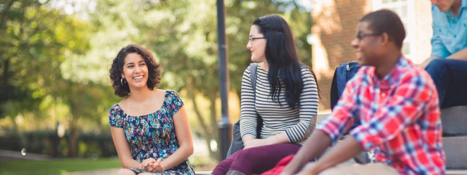 Students chat at Regent University, which offers a community college transfer guide.