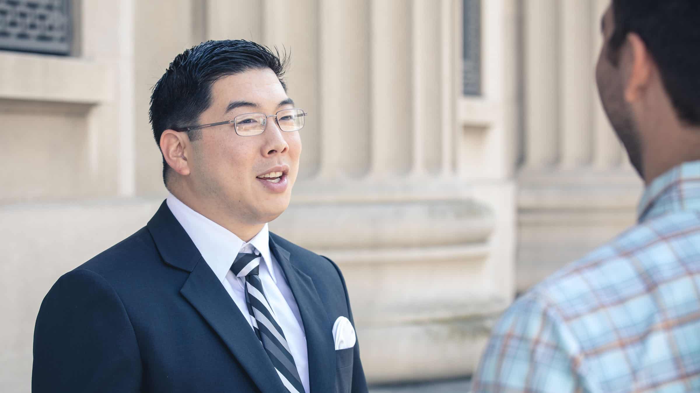An alumnus interacts with another person: Learn political campaign marketing.