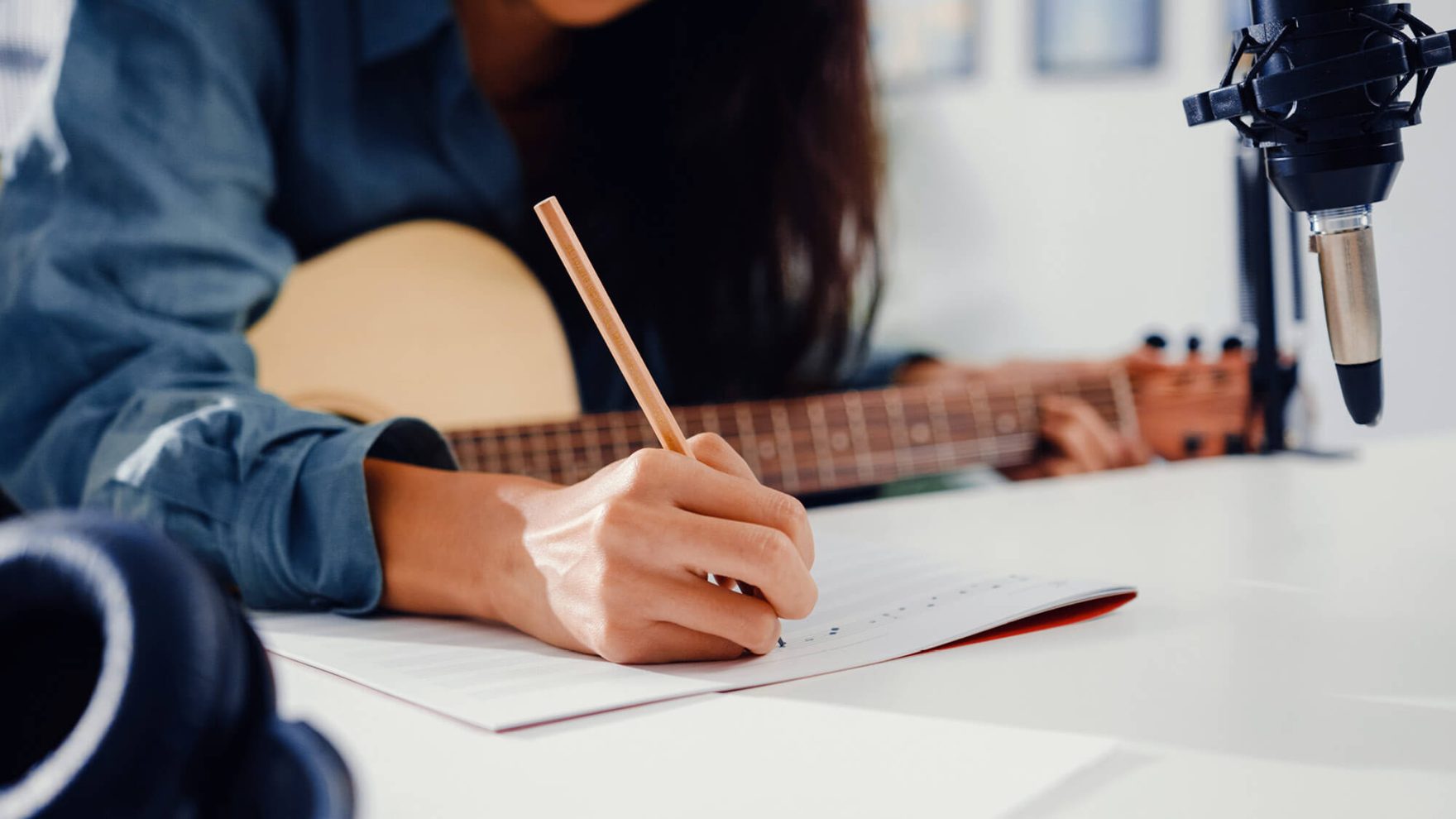 A student writing a song at Regent University: Explore our songwriting degree program.
