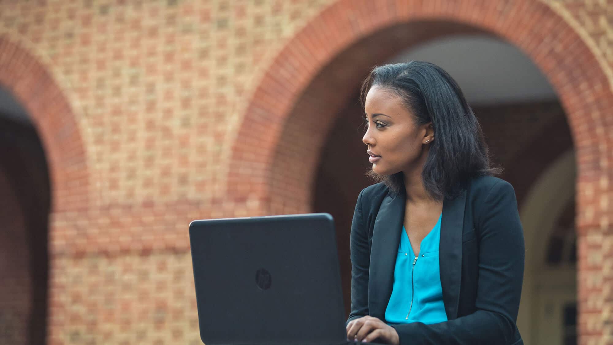 A Regent student with her laptop: Our online bachelor's programs have been ranked as number 1 in Virginia.