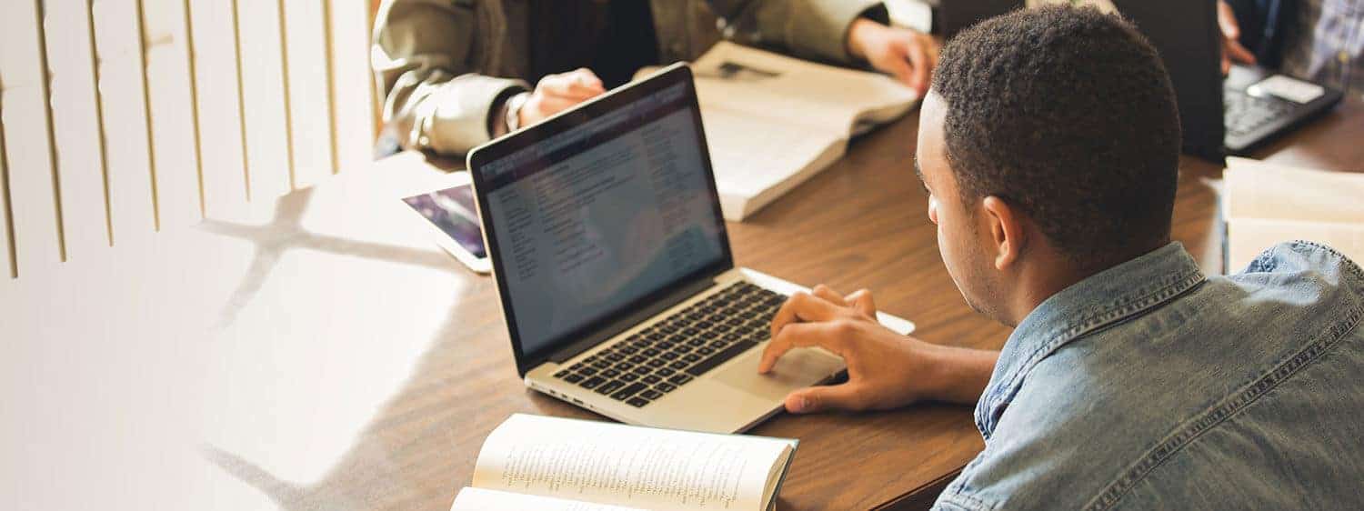 A student studying online at Regent, a university that offers a streamlined admissions process.