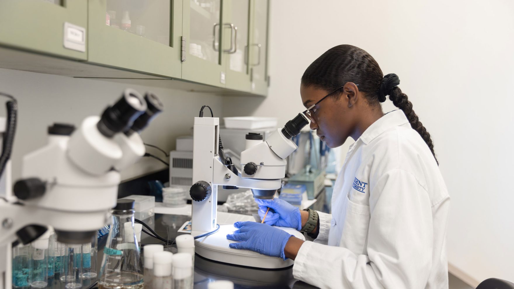 Student looking into a microscope on campus at Regent University for Pre Med Bachelor of Science