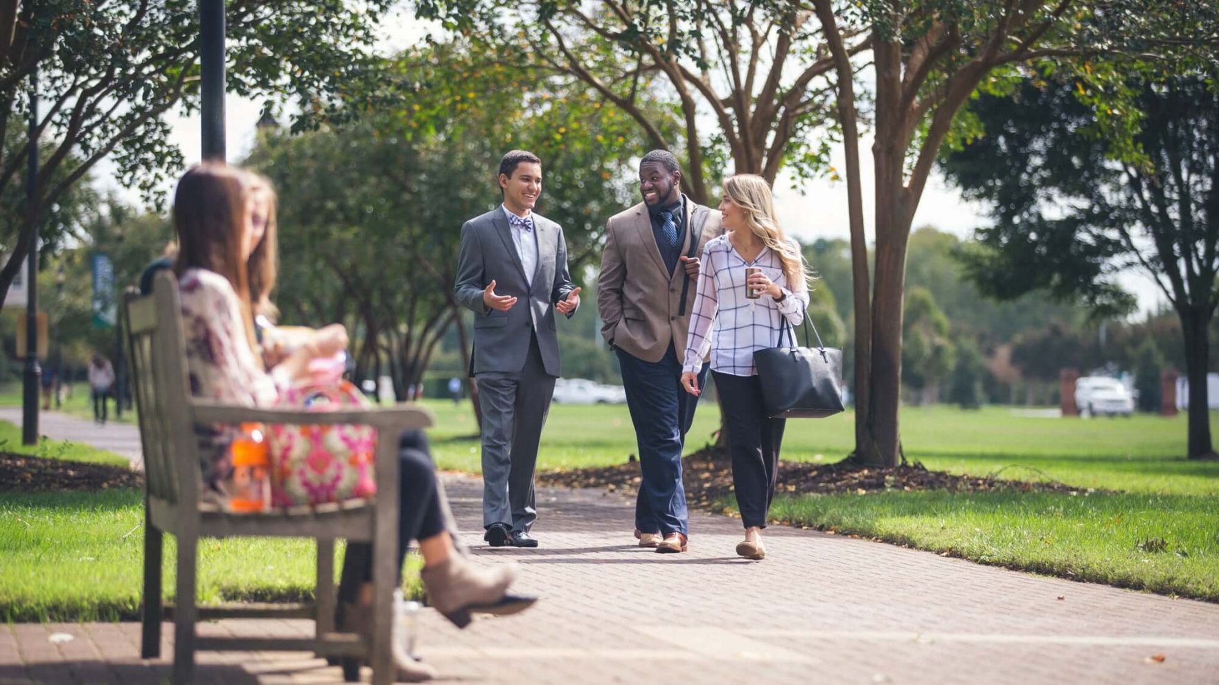 Students walking on campus: Exploring the reasons to attend Regent University.