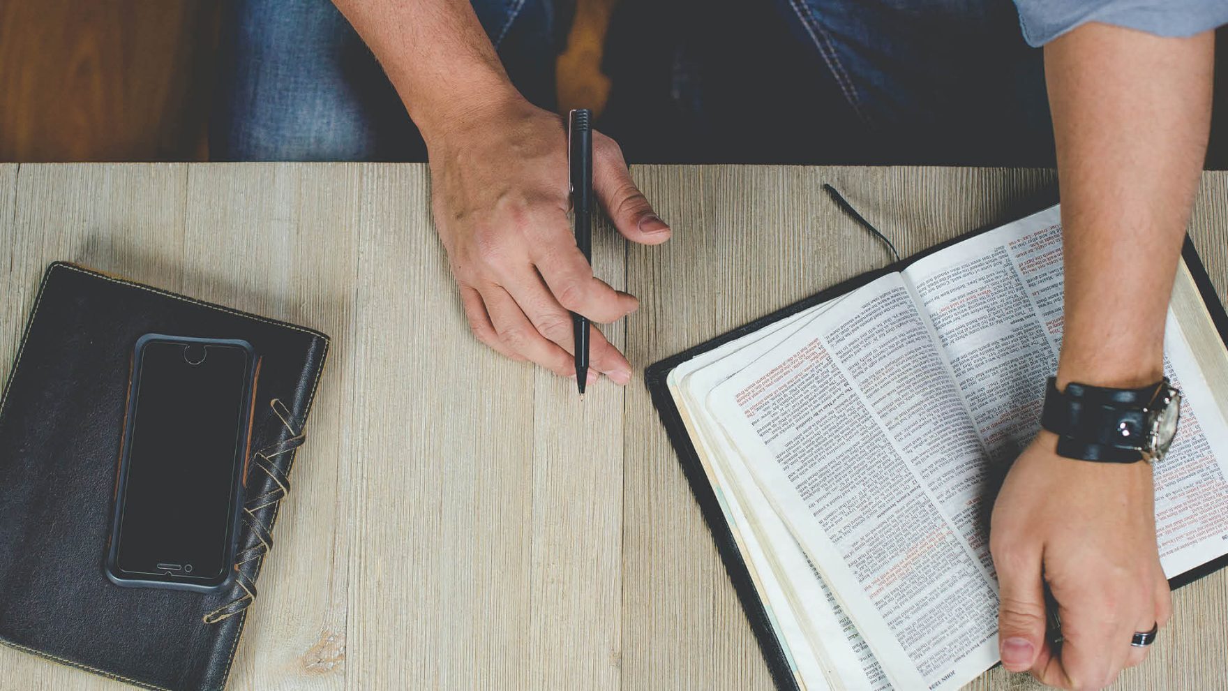 A person studying the Bible: Explore the certificate in Christian Ministry at Regent University.