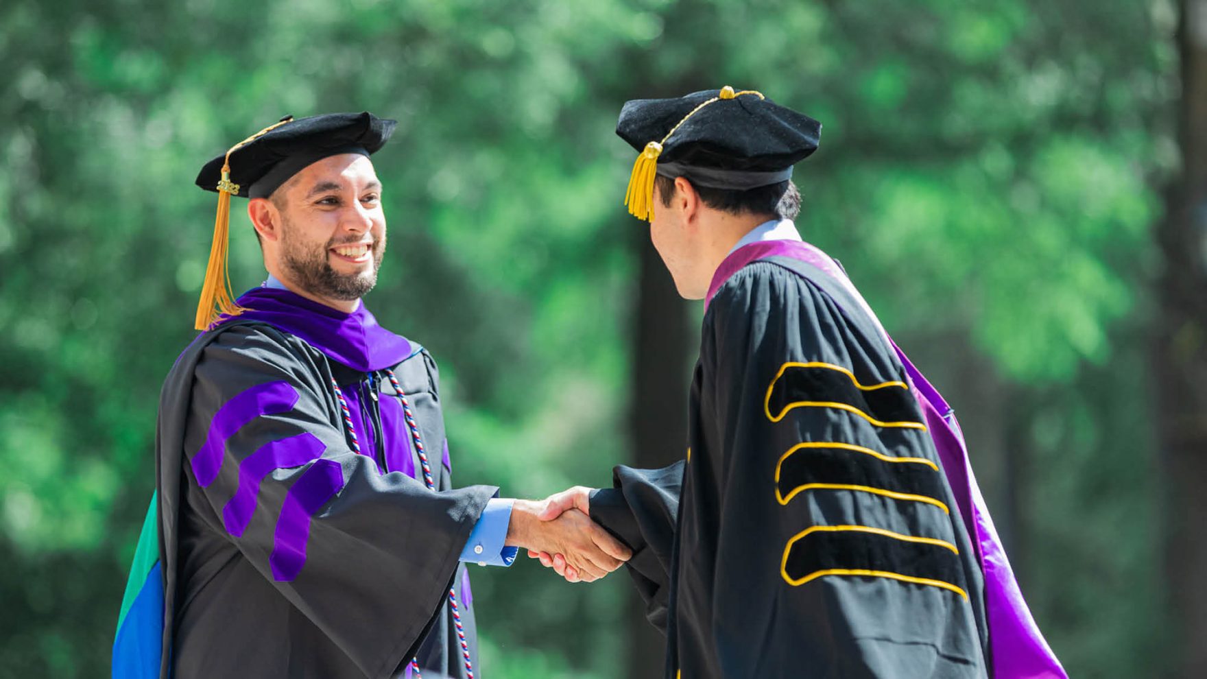 A graduate being congratulated during commencement at Regent University Virginia Beach VA 23464.