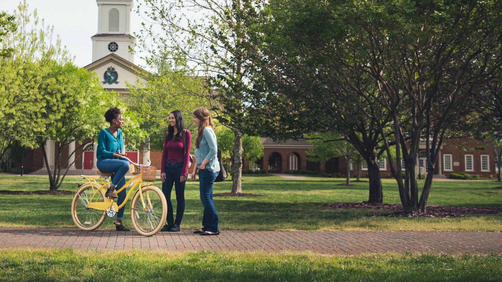 Students stand on campus at Regent University, one of the best colleges and universities in Virginia.
