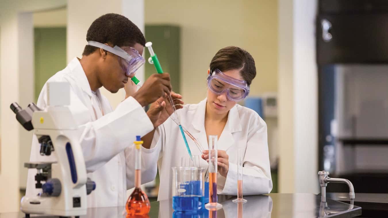 Regent University students at a lab: Explore bachelor's and associate degree programs.