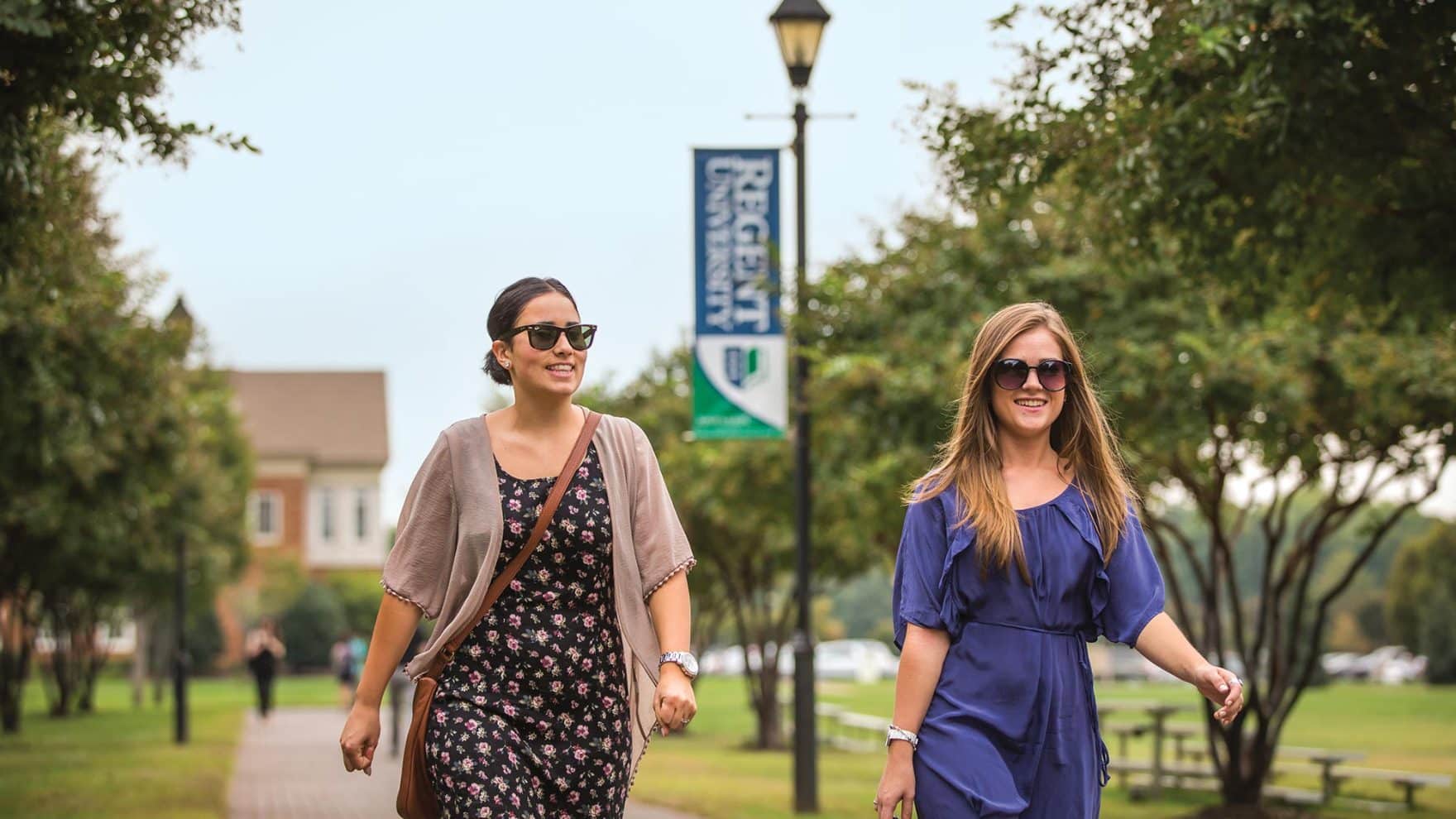 Two women walk on the Regent campus. Learn more about myths about college.
