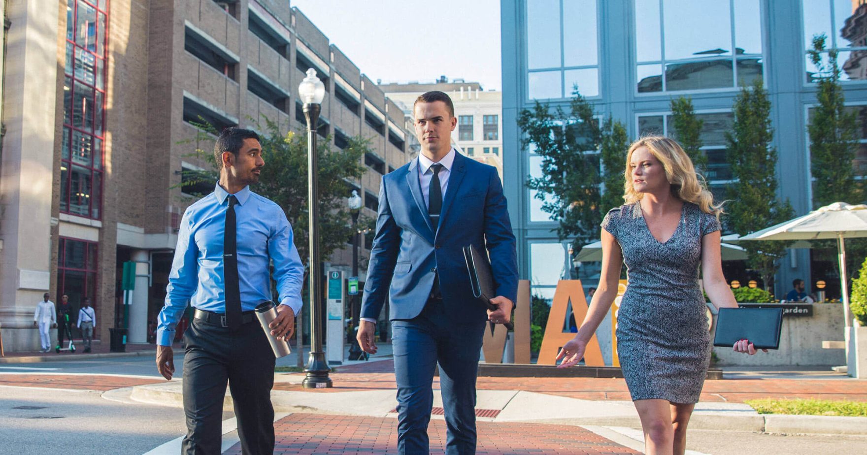 Three executives crossing a street: Regent's online MBA program has been recognized as number 1 for return on investment (ROI).