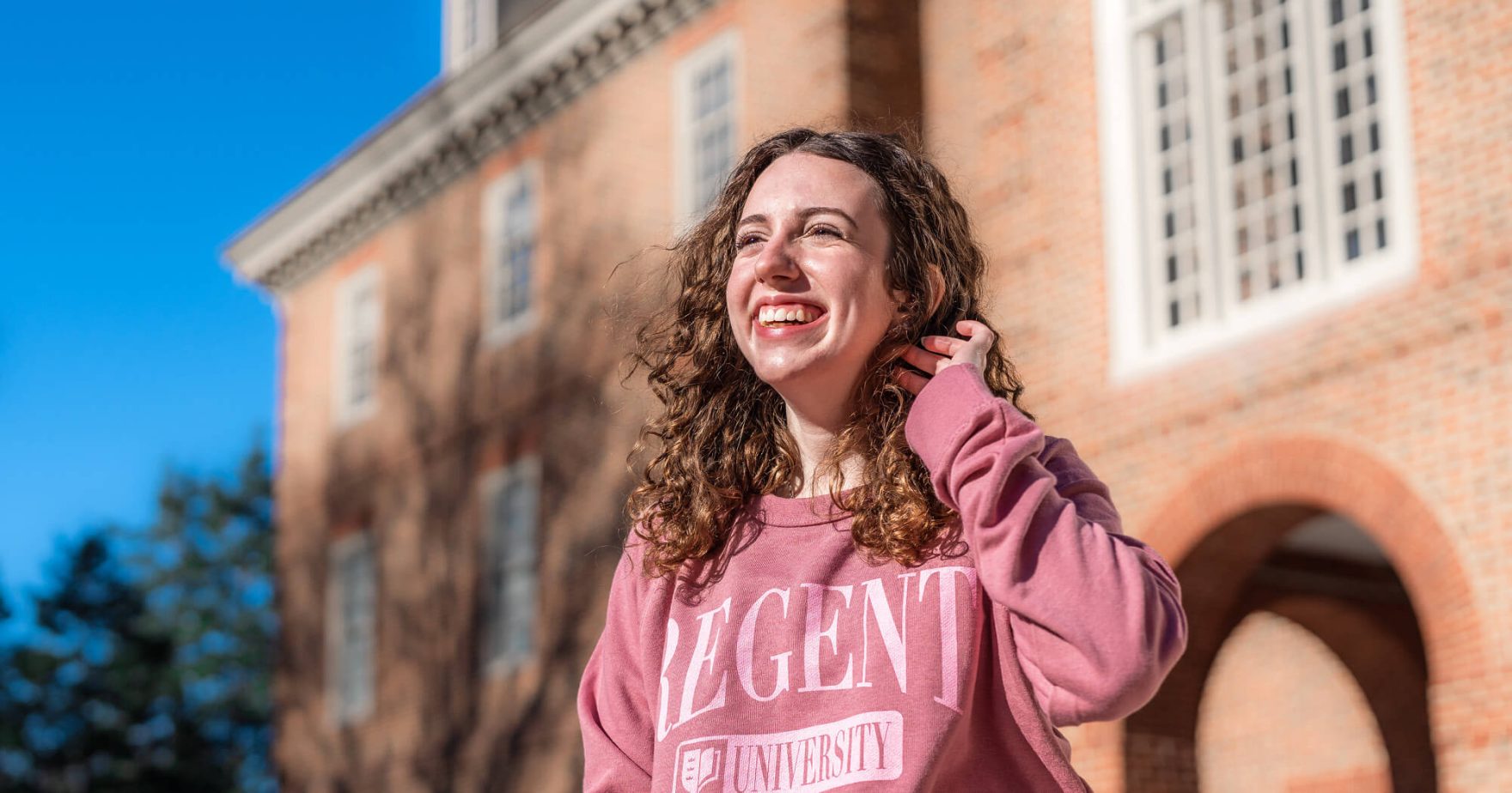 Student Smiling: Explore Regent University, a Christian University in Virginia.