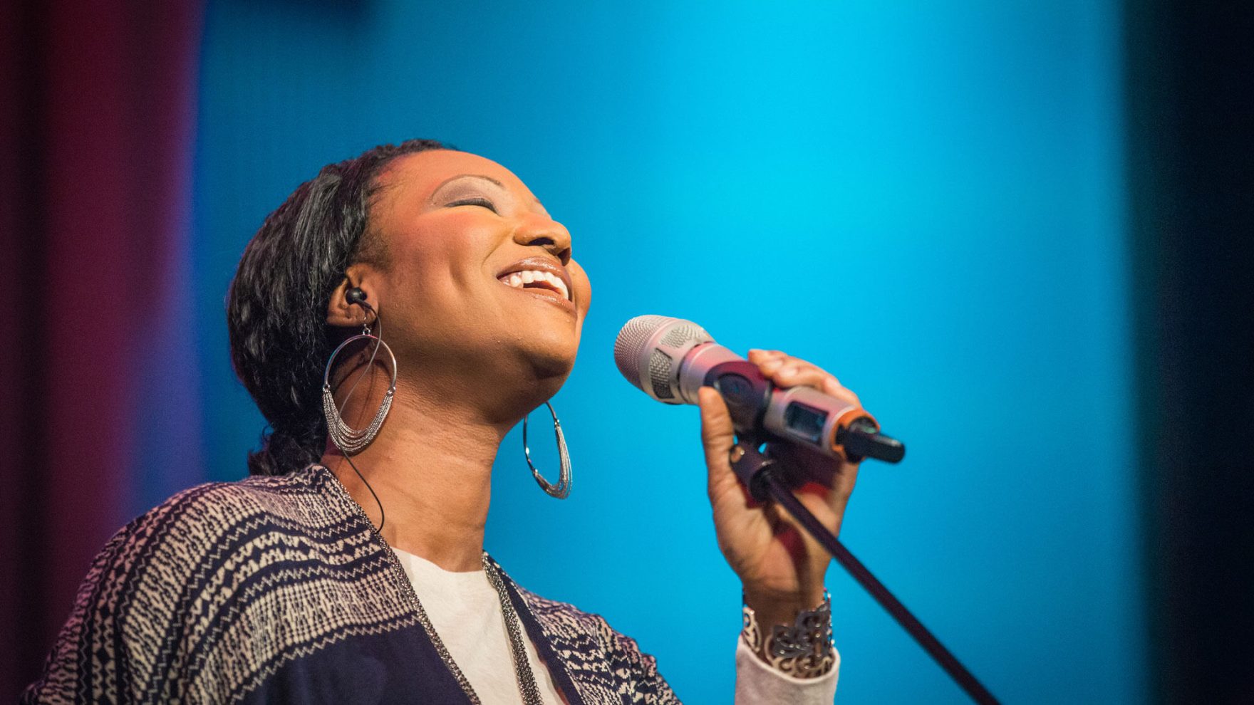 A student leading worship at Regent University: Explore our songwriting degree program.