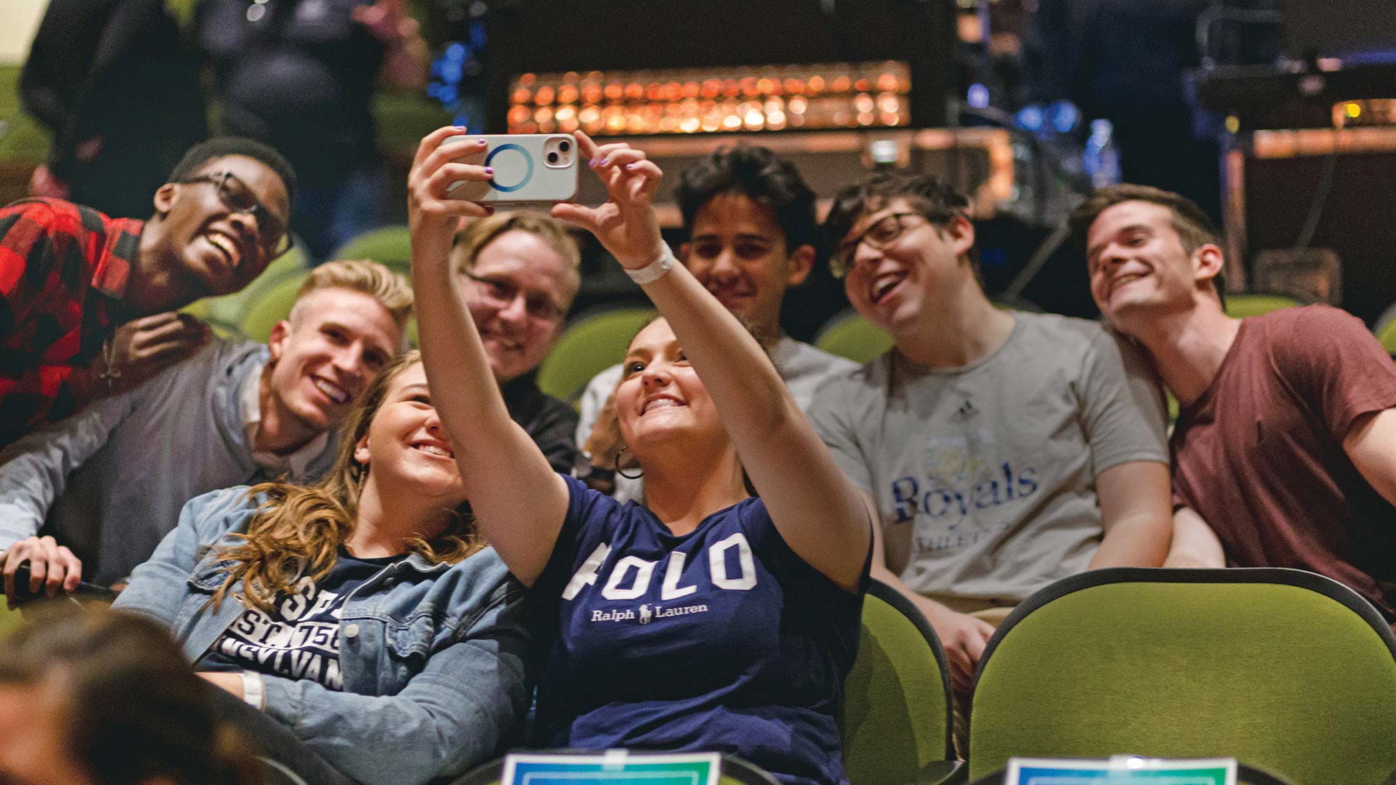 A group of Regent University freshmen taking a selfie in the on-campus theater.