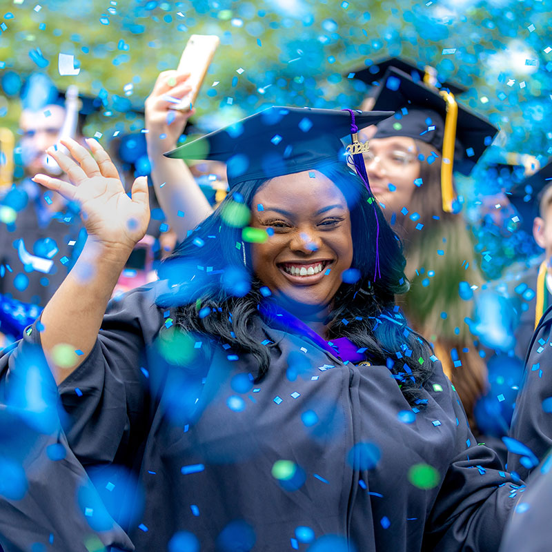 Graduates celebrate at graduation as confetti comes down at Regent University in Virginia Beach.