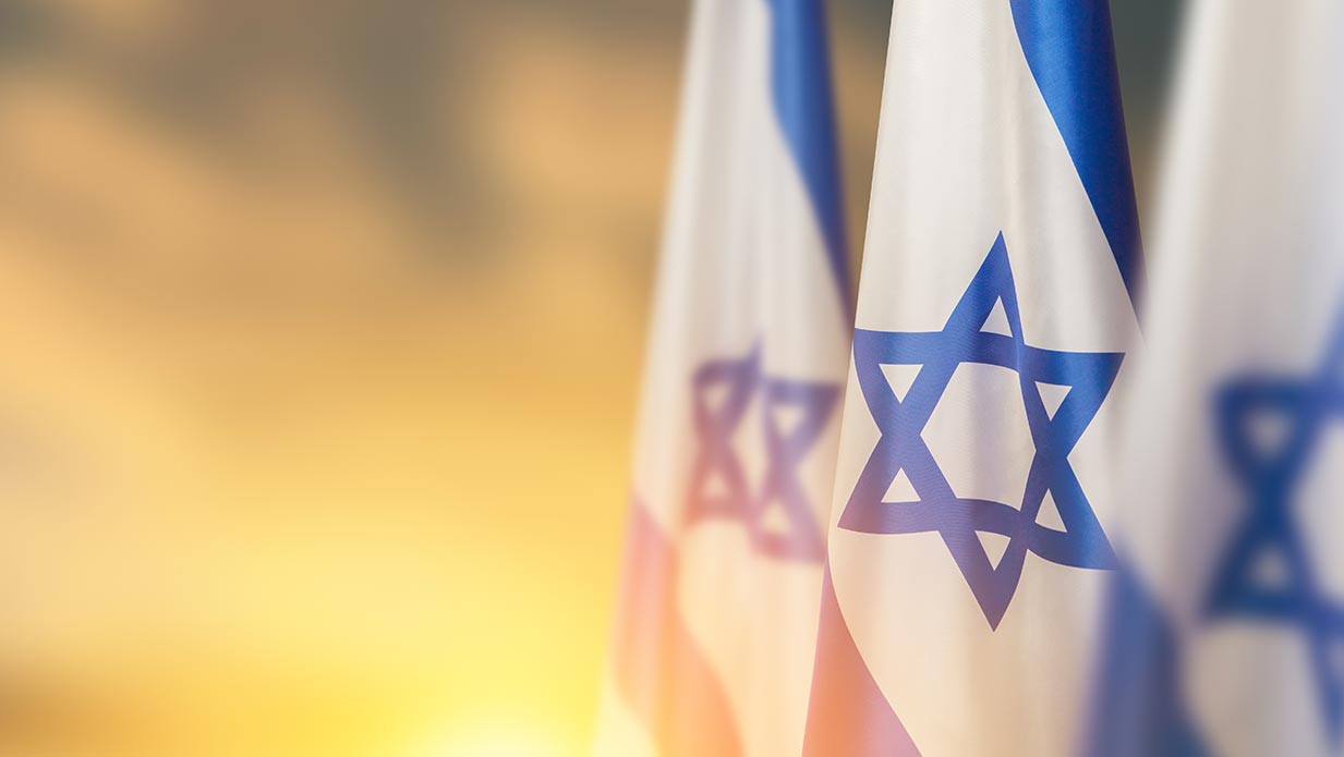 Two Israel flags next to resources for the Israel Institute at Regent University in Virginia Beach.