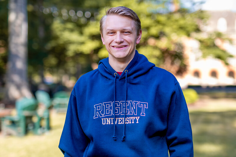 Male Regent University student in blue hoodie.