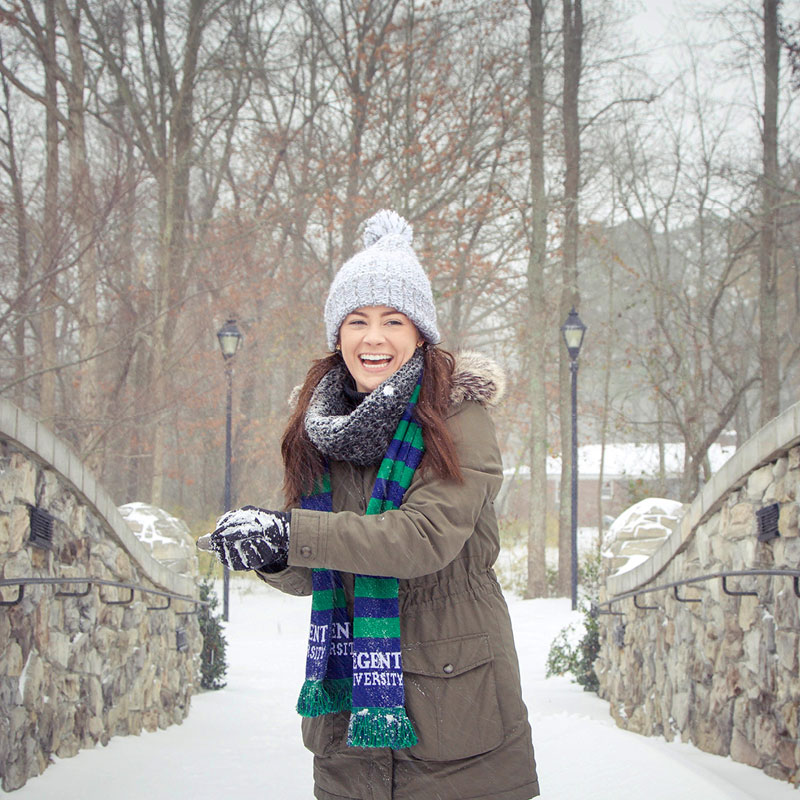 Student throwing a snowball on the Regent University college campus in Virginia Beach, VA