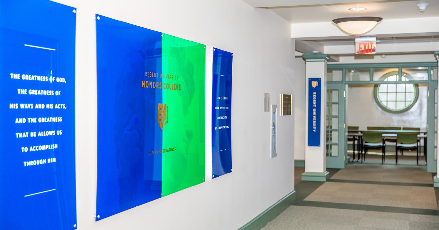 Regent University Honors College with green and blue flags in the hallway