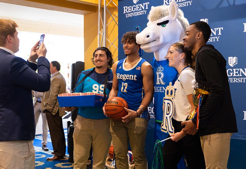 Regent University athletic takes pictures at the Night of Giving event