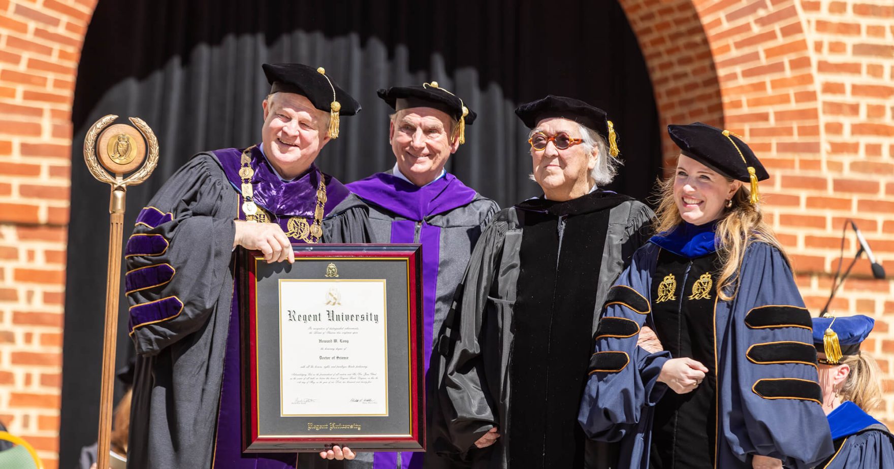 Howard W. Long holding his Honorary Doctorate with Regent Faculty