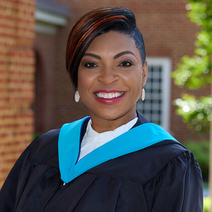 Jade Simmons in graduation regalia after earning her Master of Arts from Regent University