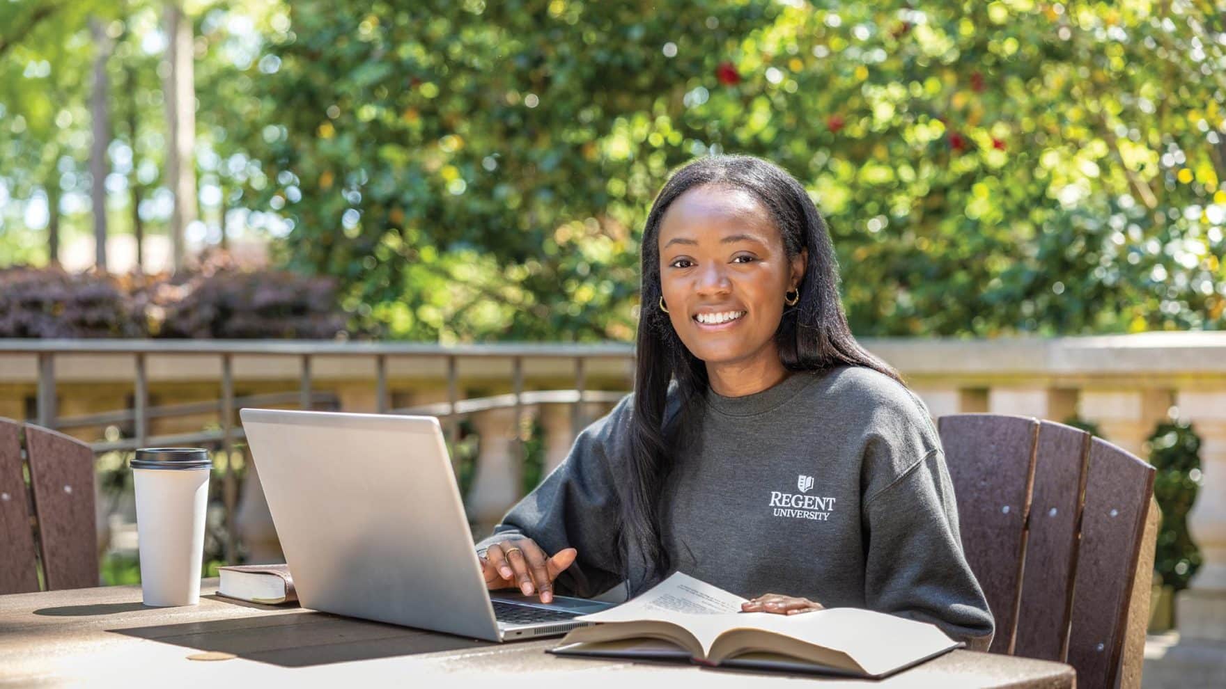 A student smiles during class: Learn about Regent perks for alumni.