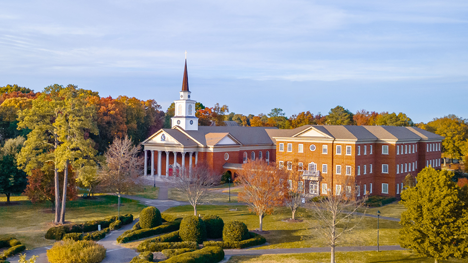 Aerial view of Regent University’s Chapel and surrounding campus in autumn colors