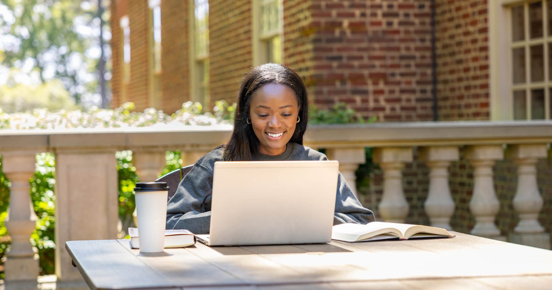 Regent student working on a laptop.