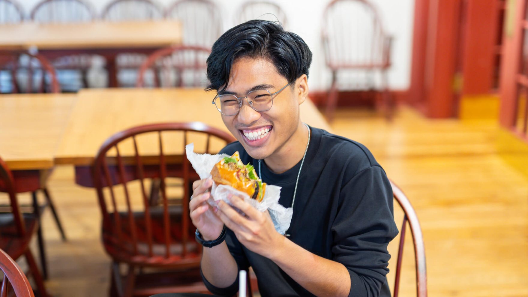 Student eating at the Ordinary Cafe, Regent's campus dining service, in Virginia Beach