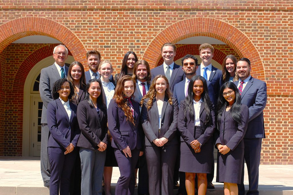 Regent University School of Law Associate board members standing on the steps outside Robertson Hall.