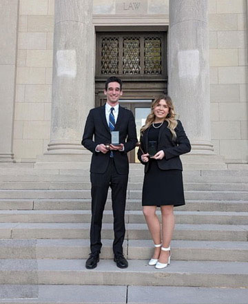 Moot Court team seated at counsel table during a competition round