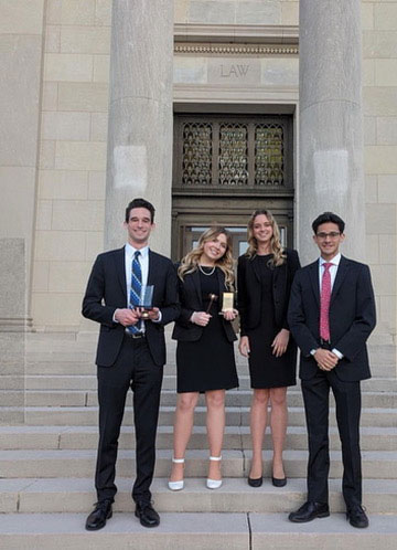 Two team members holding an AMCA Mid South Regional Semifinalist plaque