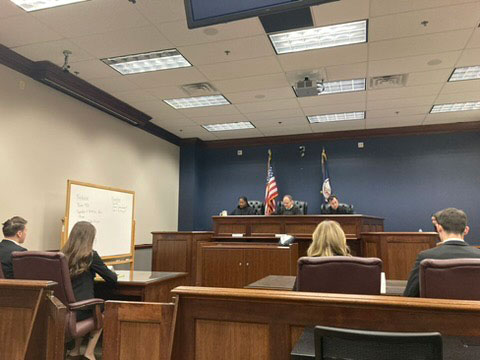 Respondent team seated at the table before a round