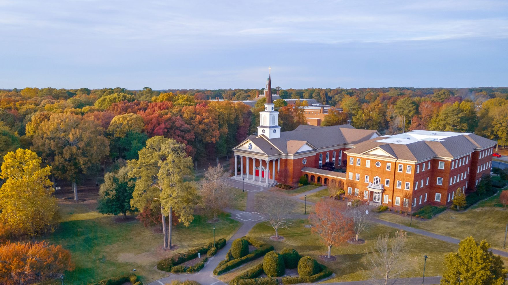 Picture of a chapel building surrounded by trees on campus at Regent University in Virginia Beach, Virginia.