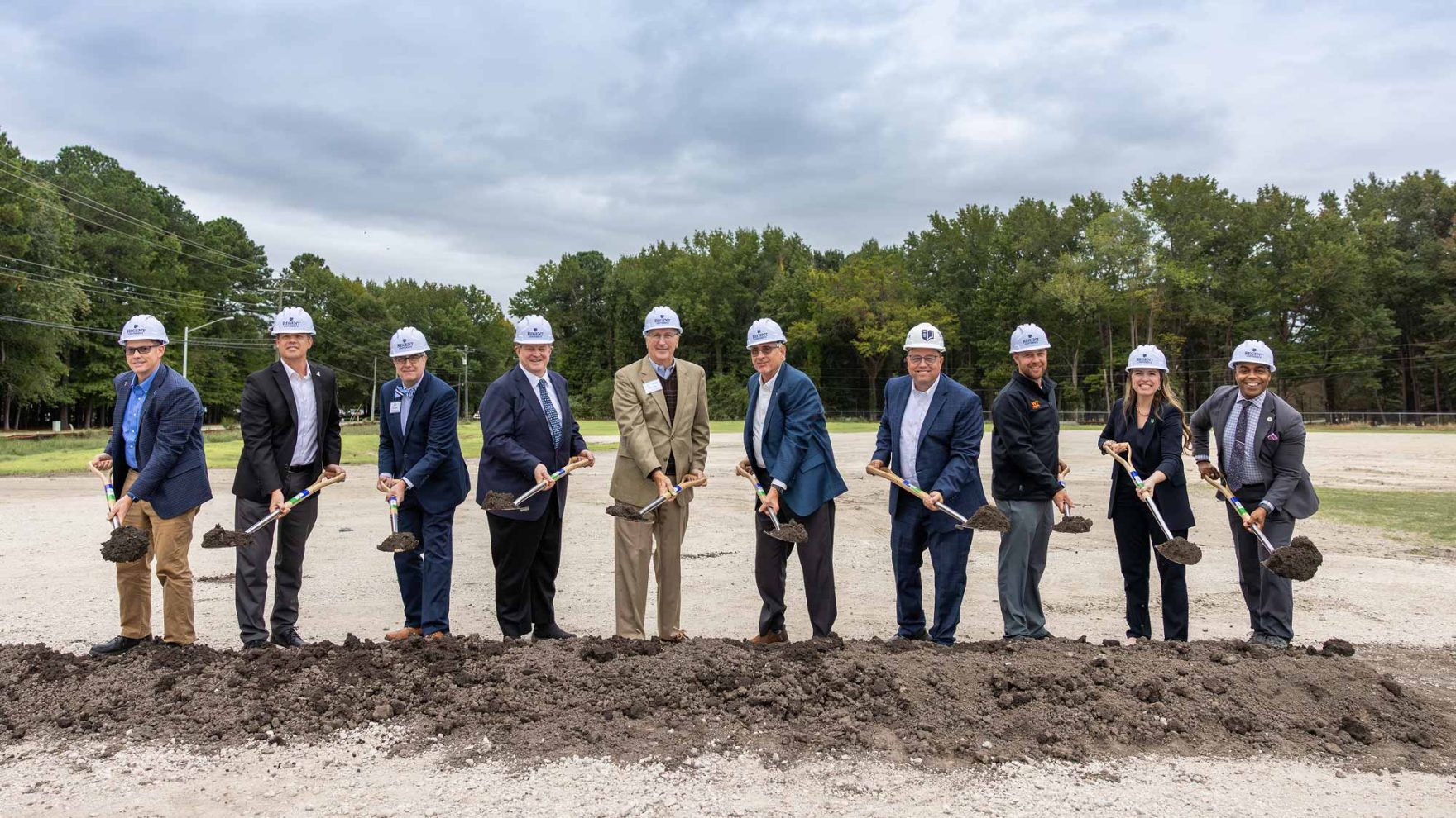 Regent University leaders holding shovels and breaking ground during Groundbreaking Ceremony for new Athletic & Fitness Center on the new ground at Regent University in Virginia Beach, Virginia.