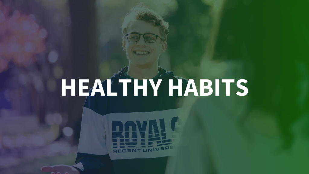 Healthy Habits - A young man wearing glasses and a Regent University Royals sweatshirt smiles outdoors in a natural setting with a gradient overlay transitioning from blue to green
